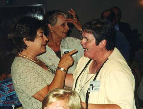 Mary C. & Bev H. with Kay H. looking bewildered in the background.